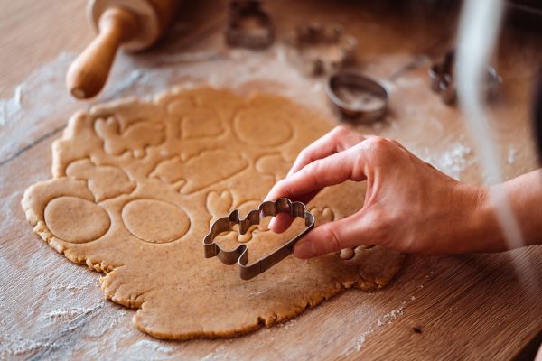 Cutting out Easter Gingerbread Cookies with a Lamb Shape Free Photo