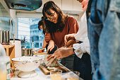 Group of friends preparing dinner together in the kitchen