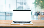 Modern computer,laptop with blank screen on counter bar(retail store shop)and window view