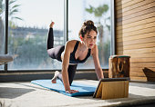 Portrait Of A Beautiful Woman Training At Home And Watching Online Lessons In The Digital Tablet