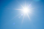Direct ray of the sun in the blue sky