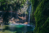 25 Fontes waterfalls in the mountains near Rabaçal and Levada do Risco walkway on Madeira island during a beautiful summer day