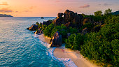 Anse Source d'Argent, La Digue Seychelles, young couple men and woman on a tropical beach