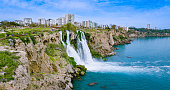 Duden waterfall dropping in Mediterranean Sea in Antalya, Lara Antalya in a bright sunny day, Lower Duden Waterfalls, high waterfall pouring into the sea, the waterfall in the city falls into the sea, turkey's famous tourism destination, the highest water