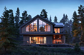 3d render of forest house with large windows at night