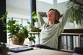 Sleep, relax and business woman finished with working on a project in office. Success, peace and calm with happy person resting after job complete, hands behind head and stretching for zen in company