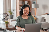 Happy, remote work and woman with a laptop for call center communication and consultation. Smile, virtual assistant and a customer service agent typing on a computer from a house for telemarketing