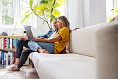 Couple at home booking a reservation online