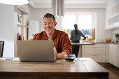 Mature man using laptop