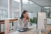Phone call, business and woman with a computer, conversation and smile with project and talking. Person, office and employee with pc and worker with joy and laughing with communication and discussion