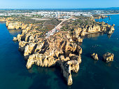 Ponta da Piedade, aerial view of famous rock formations with arches at sunset, Lagos, Algarve, Portugal.