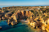 Camilo beach (Praia do Camilo) in Lagos, Algarve, Portugal. Wooden footbridge to the beach Praia do Camilo, Portugal. Picturesque view of Praia do Camilo beach in Lagos, Algarve region, Portugal.
