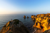 Man admiring cliffs at sunrise