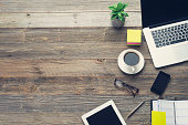 Technology and coffee on a wooden table.