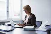 Businesswoman using laptop in office