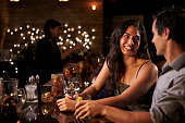 Couple Enjoying Night Out At Cocktail Bar