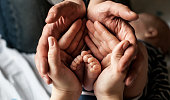 Little child foot in parents palms