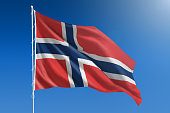 National flag of Norway on clear blue sky