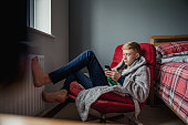 Teenage Boy Relaxing in his Bedroom