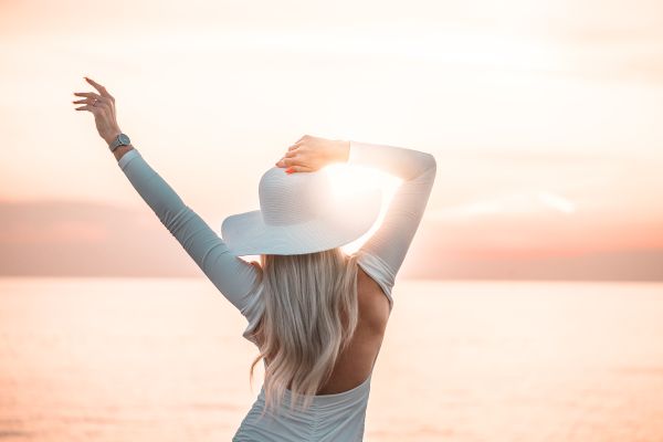 Woman Enjoying the Sunset by the Sea Free Stock Photo
