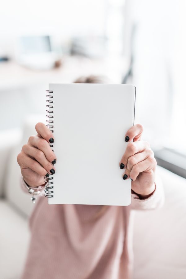 Woman Holding Blank Notebook Free Photo