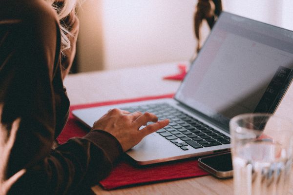 Woman Using Her Laptop Comfortably at Home Free Stock Photo