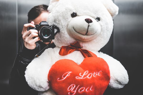 Young Man Taking Selfie with Big Teddy Bear for His Girlfriend in Elevator Free Stock Photo